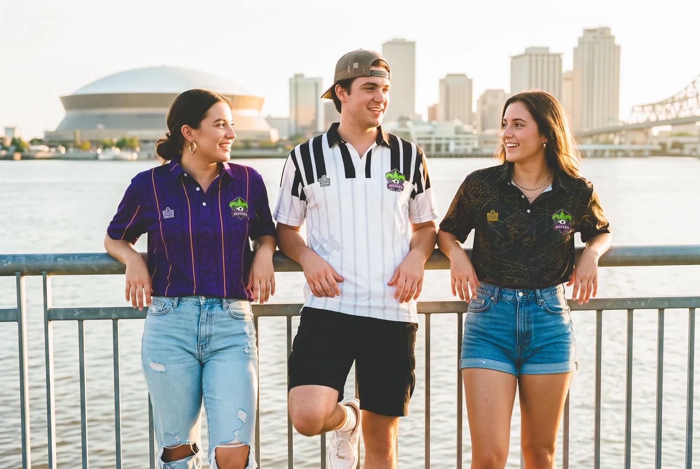 Supporters wearing the purple, white, and black Jesters polo shirts